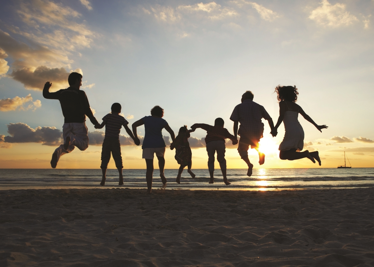 Silhouette of Family Jumping on Beach